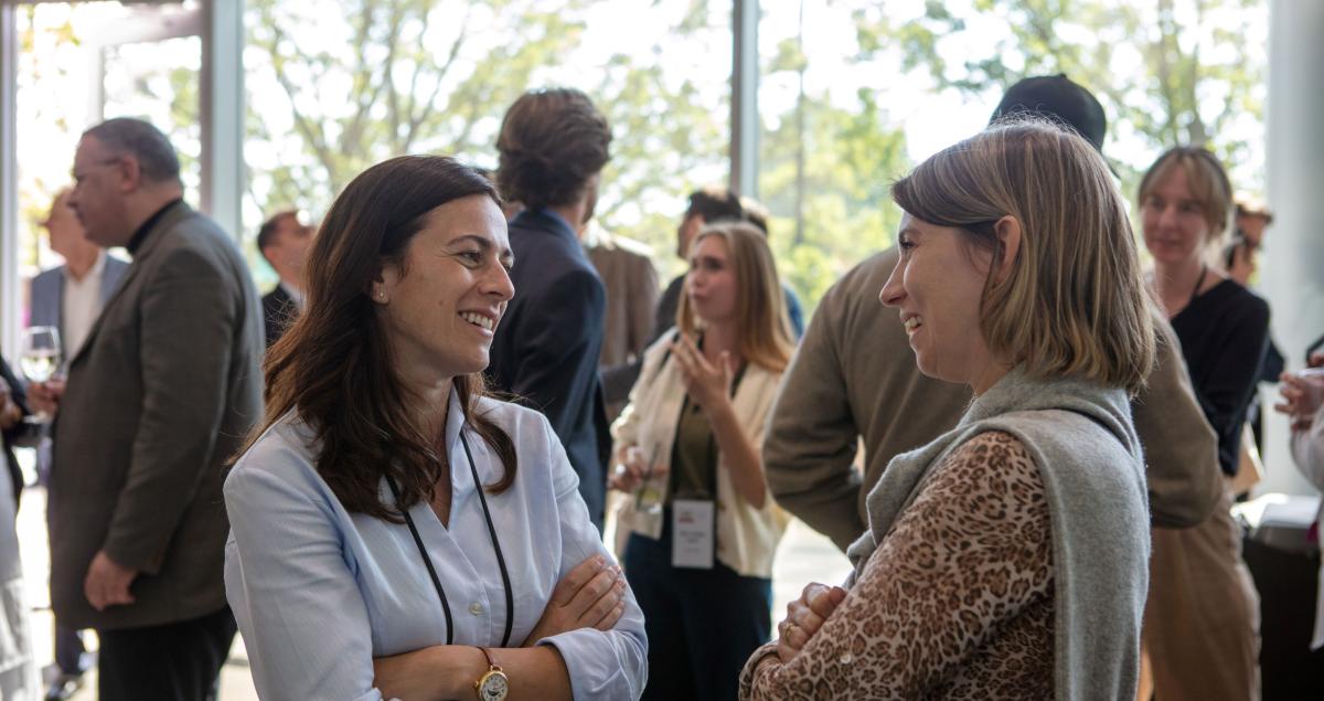 Friends mingling after a lecture.